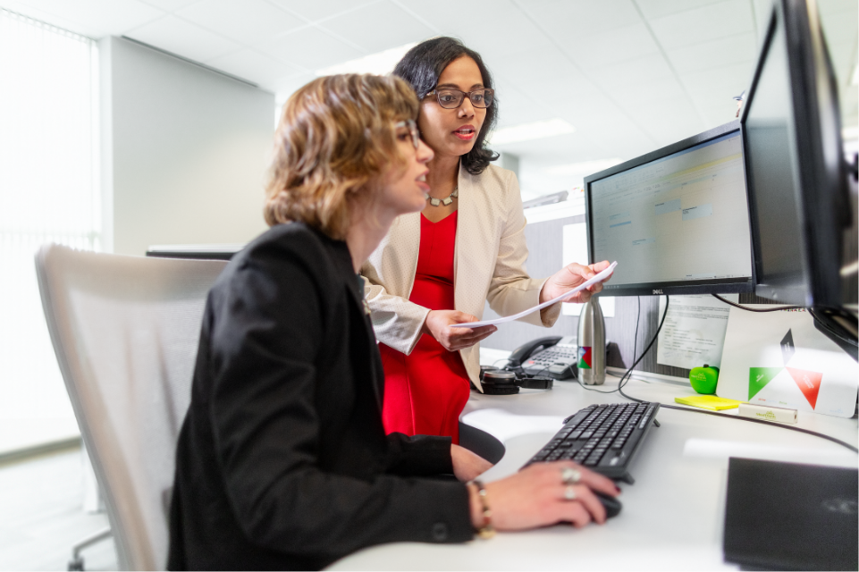 Employees of MedThink Inc, healthcare marketing agency reviewing data on computers